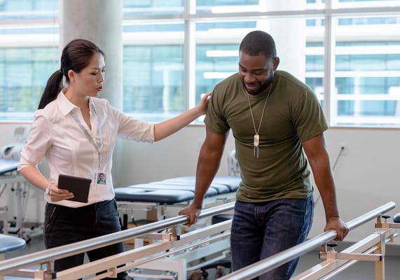 Therapist assisting a resident at a rehabilitation center