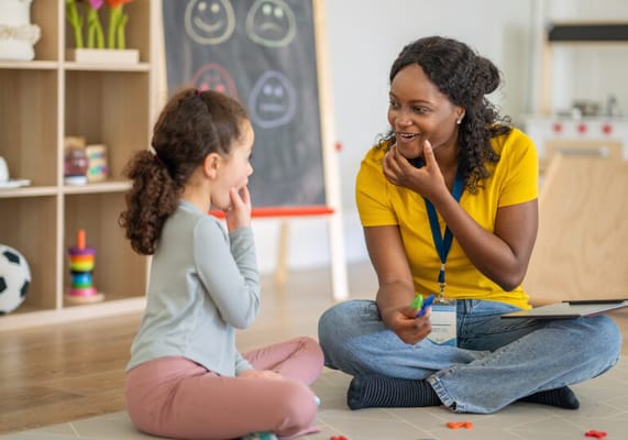 A staff member engaging with a child in an activity