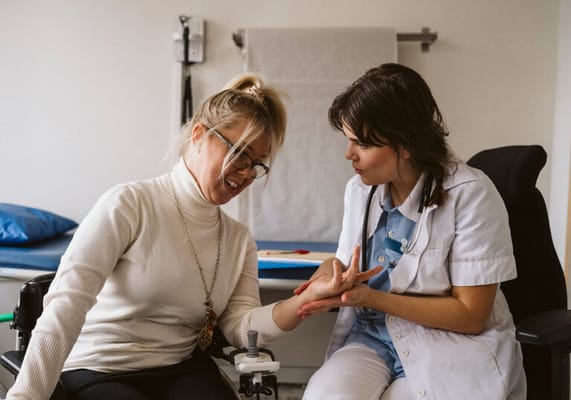 Staff assisting a resident in an interior setting