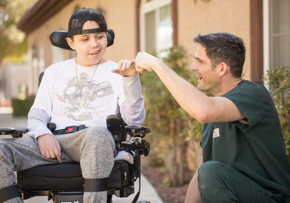Staff member engaging with a resident in a wheelchair