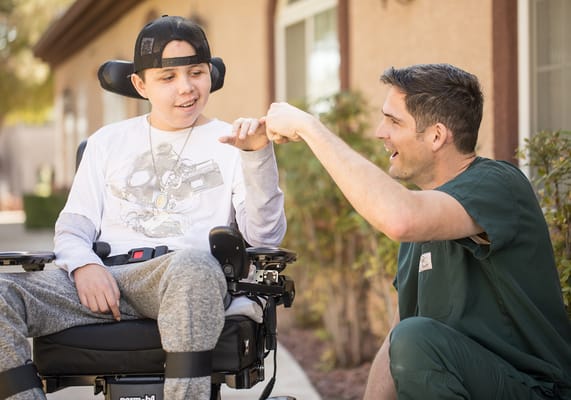 Staff member engaging with a resident in a wheelchair
