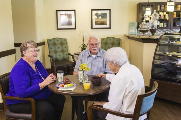 Residents enjoying snacks and conversation in a cozy common area
