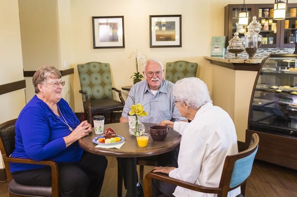 Residents enjoying snacks and conversation in a cozy common area
