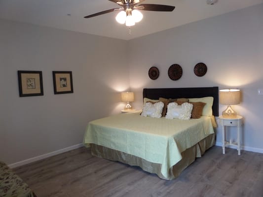 Well-decorated private resident room with a bed and lamps
