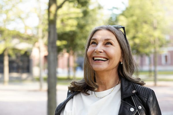 Smiling woman outdoors in a park setting