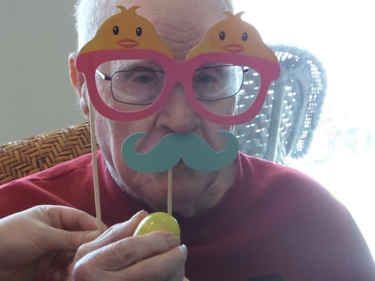 Resident enjoying a playful activity with props