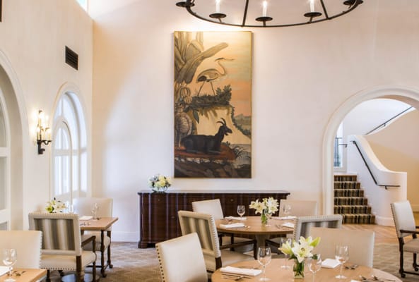 Elegant dining room with tables and a painting