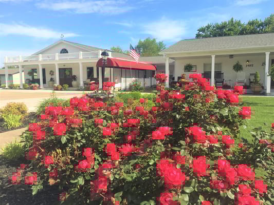Exterior view of a facility with blooming roses