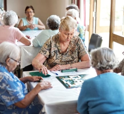 Residents engaging in an activity around a table