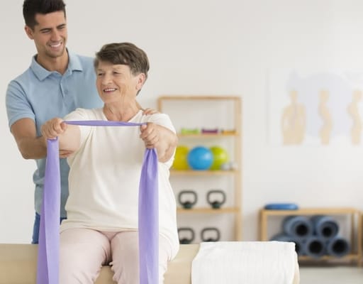 Therapist assisting a resident with exercise