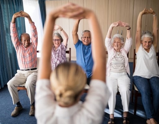 Residents participating in a group exercise session indoors