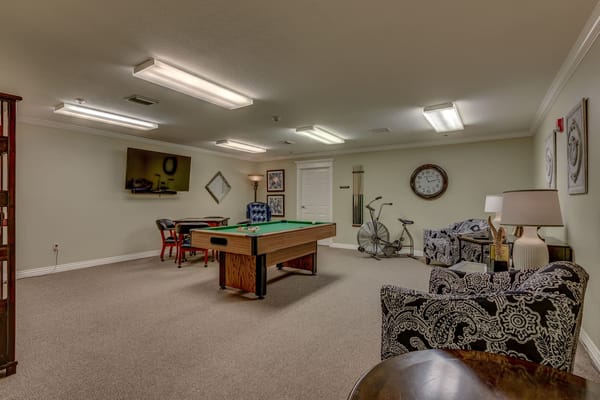 Game room with a pool table and seating area