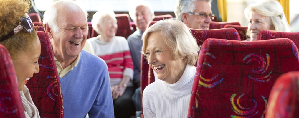 Residents enjoying laughter on a bus trip
