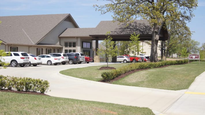 Exterior view of Brownwood Life Care Center with parking area