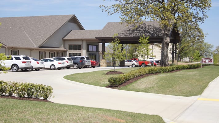 Exterior view of Brownwood Life Care Center with parking area