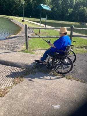 Resident fishing at a peaceful lakeside area