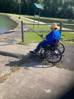 Resident fishing at a peaceful lakeside area