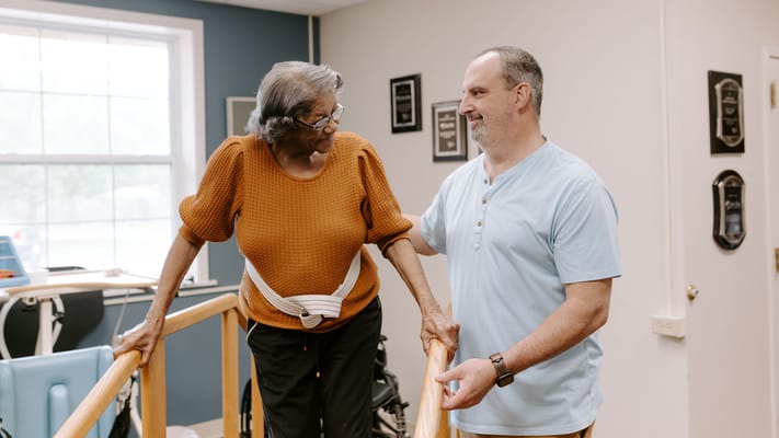 Staff assisting a resident in an interior space