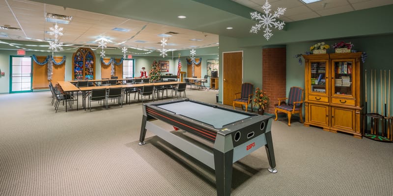 Interior view of a community room with a pool table