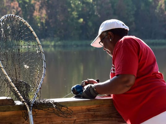Resident fishing by the water on a sunny day