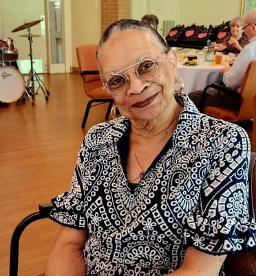 Resident smiling during an event in the common area