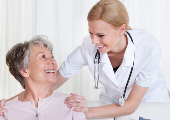 Nurse interacting with a smiling resident in a facility setting