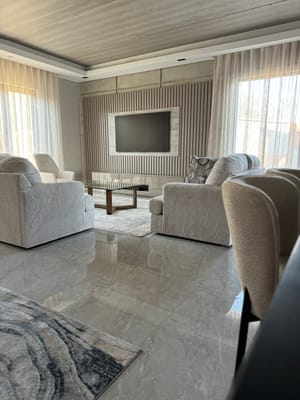 Cozy common area with comfortable seating and a TV.