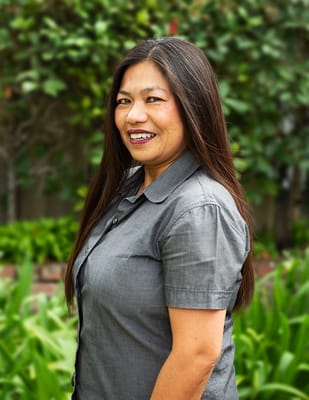 Staff member posing in a garden area