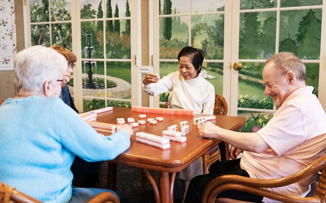 Residents playing a game in a vibrant activity room