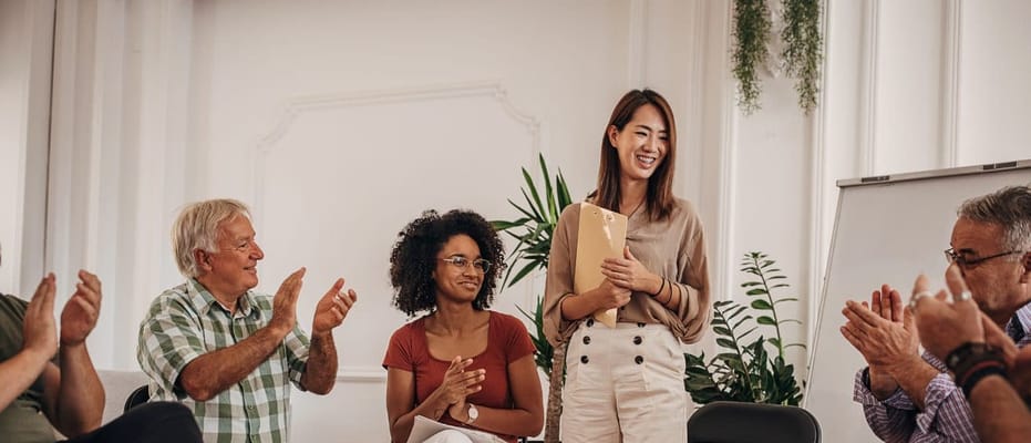 Residents and staff engaged in a celebratory meeting