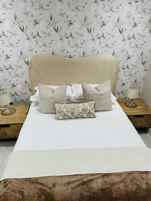 Cozy bedroom setup with soft pillows and lamps