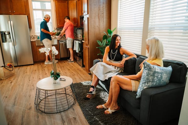 Residents chatting in a cozy living area