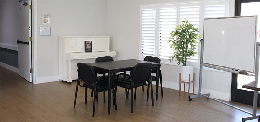 Common area with a piano and seating