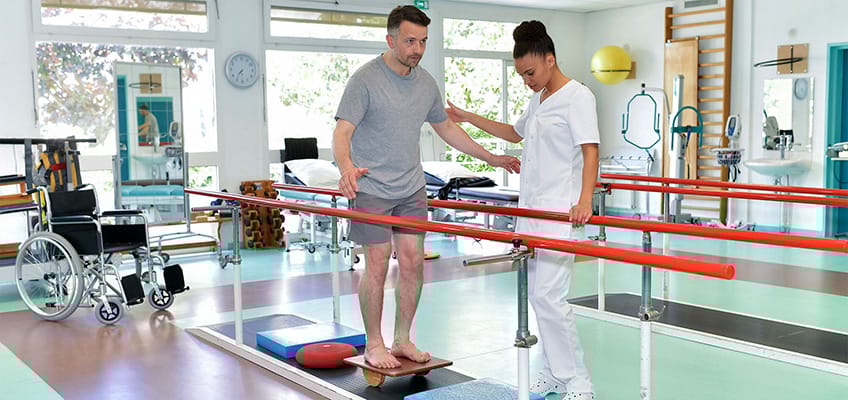Therapist assisting a resident in a rehabilitation exercise