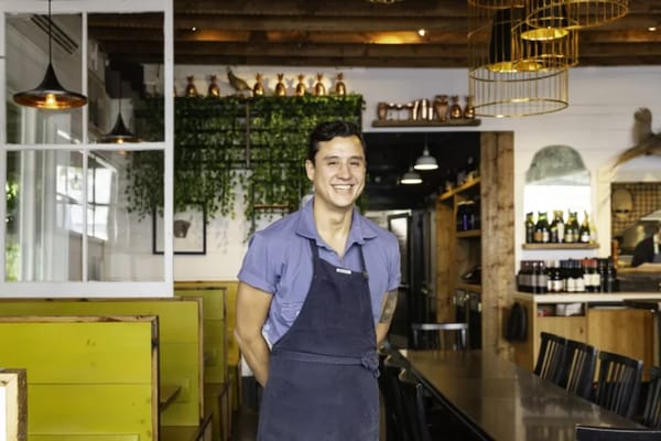 Staff member smiling in a modern dining area