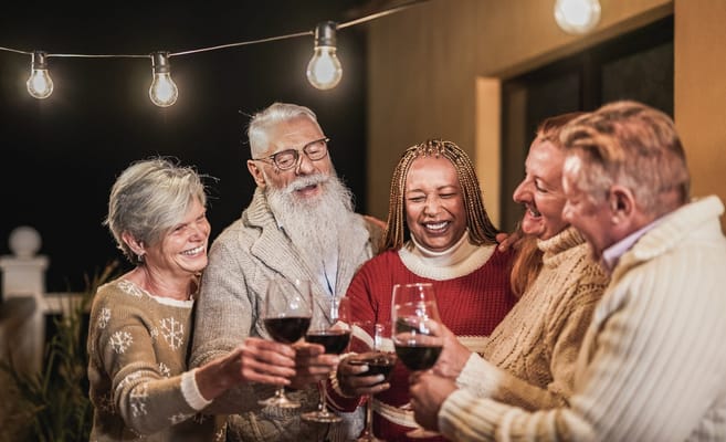Residents celebrating with drinks in a warm outdoor setting
