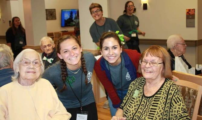Residents and staff celebrating in a common area