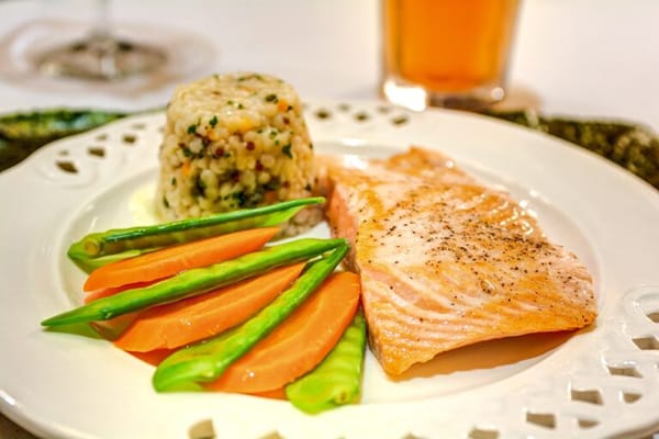 A plated meal with salmon, vegetables, and rice