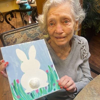 Resident holding an arts and crafts project