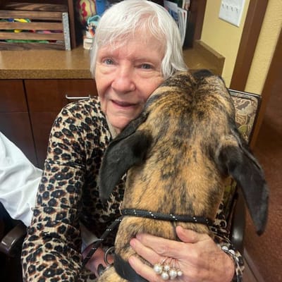 Senior resident joyfully interacting with a dog