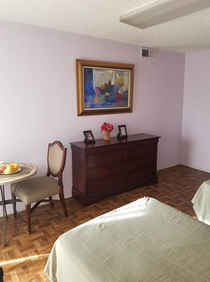 A cozy resident room with a bed and a view