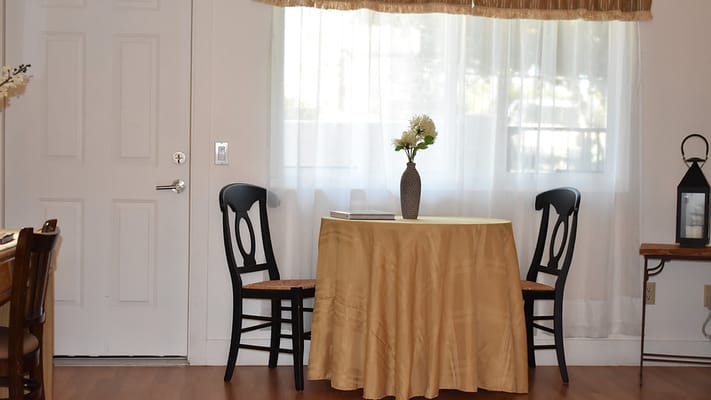 Cozy interior with a table and chairs by the window