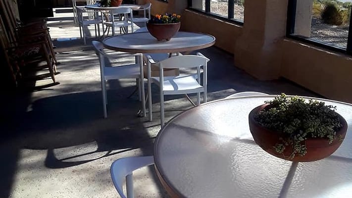 Outdoor patio area with tables and flowers