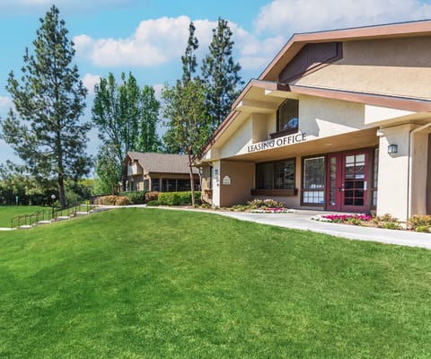 Exterior view of the leasing office with green lawn