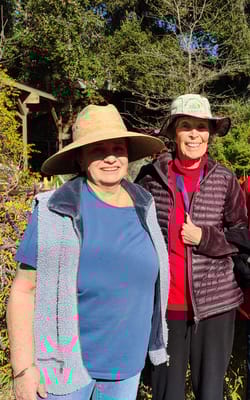 Two women enjoying time outdoors in a garden