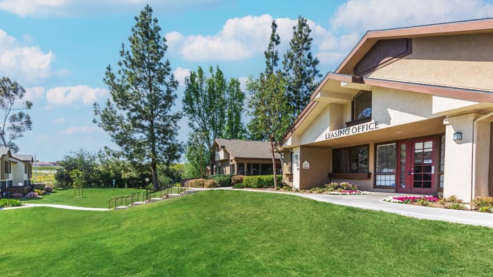 Exterior view of leasing office with landscaping