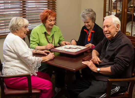 Residents enjoying a game of Scrabble in a common room