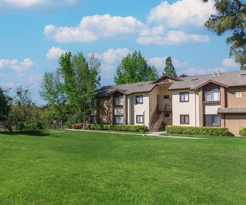 Exterior view of a senior living facility surrounded by grass
