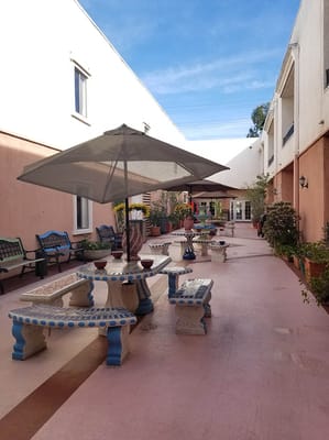Outdoor courtyard with benches and umbrellas