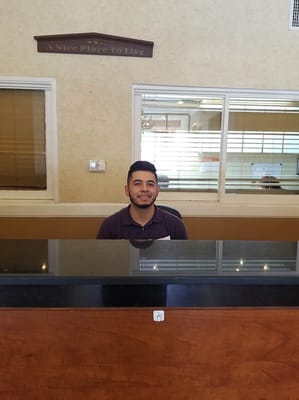 Reception area with a staff member smiling